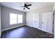 Bedroom with hardwood floors, two windows, a ceiling fan, and a closet at 2220 Badin Rd, Albemarle, NC 28001