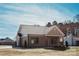 Picture of home showing backyard and driveway leading to a detached single car garage at 2220 Badin Rd, Albemarle, NC 28001
