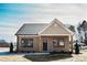 Charming single-story home featuring a stylish front door, wood accents, and lush green landscaping at 2220 Badin Rd, Albemarle, NC 28001