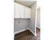 Practical laundry room with overhead cabinets and hookups at 2220 Badin Rd, Albemarle, NC 28001