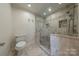 Large walk-in shower with tiled walls and seat at 2420 Carson Dr, Waxhaw, NC 28173