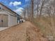 View of the property's backyard, including the storage shed, fence, and adjacent trees at 3020 Graceland Cir # 11D, Pineville, NC 28134