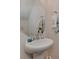 Elegant powder room with a modern pedestal sink, decorative mirror, and stylish fixtures at 3020 Graceland Cir # 11D, Pineville, NC 28134