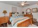 Comfortable bedroom with a wooden bed frame, ceiling fan, and decorative accents at 3020 Graceland Cir # 11D, Pineville, NC 28134