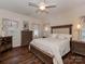 Cozy bedroom featuring a comfortable bed, hardwood floors, a ceiling fan, and ample natural light from multiple windows at 3020 Graceland Cir # 11D, Pineville, NC 28134