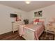 Bedroom featuring wood floors, a vintage dresser, and TV at 3020 Graceland Cir # 11D, Pineville, NC 28134