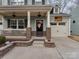 Inviting front entrance featuring a covered porch with brick columns and a decorated door at 3020 Graceland Cir # 11D, Pineville, NC 28134