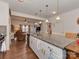 Modern kitchen featuring a large island with granite countertops and stainless steel appliances, open to the living area at 3020 Graceland Cir # 11D, Pineville, NC 28134