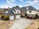 Brick two-story house with three-car garage and landscaped yard at 3408 Out Of Bounds Dr, Monroe, NC 28112