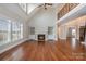 Spacious living room with hardwood floors, fireplace, and high ceilings at 3408 Out Of Bounds Dr, Monroe, NC 28112