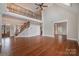 Two-story living room with hardwood floors, elegant staircase, and high ceilings at 3408 Out Of Bounds Dr, Monroe, NC 28112