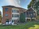 Back exterior showing a brick facade, multiple windows, and a screened porch at 3827 Bramwyck Dr, Charlotte, NC 28210