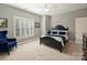 Comfortable bedroom with a large window, a ceiling fan, and neutral paint at 3827 Bramwyck Dr, Charlotte, NC 28210