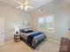 Comfortable bedroom with a ceiling fan, large window, and a stylish color scheme at 3827 Bramwyck Dr, Charlotte, NC 28210