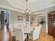 Elegant dining room with chandelier lighting, hardwood floors, and arched entryways at 3827 Bramwyck Dr, Charlotte, NC 28210