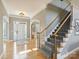 Inviting foyer with hardwood floors, staircase, arched entryways, and natural light at 3827 Bramwyck Dr, Charlotte, NC 28210