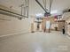 Well-organized garage with storage cabinets and epoxy flooring at 3827 Bramwyck Dr, Charlotte, NC 28210