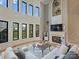 Open living room with two story fireplace and many windows at 3827 Bramwyck Dr, Charlotte, NC 28210