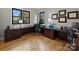 Spacious home office with hardwood floors, dark wood desk, and natural light at 3827 Bramwyck Dr, Charlotte, NC 28210