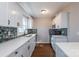 Updated kitchen with white cabinets, quartz countertops, and blue tile backsplash at 4700 Hartland Cir, Charlotte, NC 28205