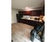 Kitchen with dark wood cabinets and a black refrigerator at 4818 Highlake Dr, Charlotte, NC 28215