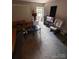 Living room features carpet flooring, a couch, and a rocking chair at 4818 Highlake Dr, Charlotte, NC 28215