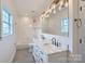 Bathroom with double vanity, marble countertop, and white subway tile at 502 E 2Nd St, Salisbury, NC 28146