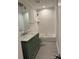 Bathroom with a green vanity, white subway tiles, and a bathtub at 502 E 2Nd St, Salisbury, NC 28146