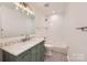 Modern bathroom with subway tile, green vanity, and bathtub at 502 E 2Nd St, Salisbury, NC 28146
