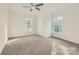 Bright bedroom with neutral carpet, ceiling fan and multiple windows at 502 E 2Nd St, Salisbury, NC 28146