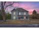 Two-story house with gray siding, front porch, and a tree at 502 E 2Nd St, Salisbury, NC 28146