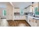 Modern kitchen with white cabinets, granite countertops, and wood-look flooring at 502 E 2Nd St, Salisbury, NC 28146