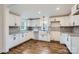 Modern kitchen with white cabinets, granite countertops, and wood-look flooring at 502 E 2Nd St, Salisbury, NC 28146