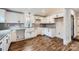 Modern kitchen with white cabinets, granite countertops, and wood-look flooring at 502 E 2Nd St, Salisbury, NC 28146