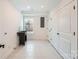 Bright laundry room with utility sink, built-in shelving, and white doors at 502 E 2Nd St, Salisbury, NC 28146