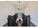 Elegant staircase with black railings and hardwood floors at 502 E 2Nd St, Salisbury, NC 28146