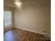 Spacious bedroom with hardwood floors and large window at 5024 Victoria Ave, Charlotte, NC 28269