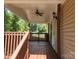 Covered front porch with wooden railings and ceiling fan at 5024 Victoria Ave, Charlotte, NC 28269