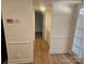 Hallway with light walls, wood-look floors and laundry area at 5024 Victoria Ave, Charlotte, NC 28269