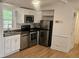 Updated kitchen with stainless steel appliances and white cabinets at 5024 Victoria Ave, Charlotte, NC 28269