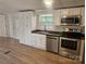Kitchen with stainless steel appliances and white cabinets at 5024 Victoria Ave, Charlotte, NC 28269