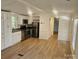 Open living space with wood-look floors and access to kitchen at 5024 Victoria Ave, Charlotte, NC 28269