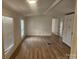 Bright living room featuring hardwood floors and large windows at 5024 Victoria Ave, Charlotte, NC 28269