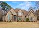 Stunning stone and brick home featuring a beautifully landscaped yard and inviting entrance at 557 Medora Ln, Fort Mill, SC 29708