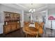 Elegant dining room with a wood hutch and table, offering ample space for entertaining at 5803 Mcclintock Dr, Denver, NC 28037