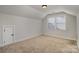 Neutral carpeted bedroom with a dormer window, and a closet, offering cozy appeal at 630 Daventry Ct, Clover, SC 29710