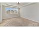 Bright bedroom with tray ceiling, carpet, and three windows that offer lots of natural light at 630 Daventry Ct, Clover, SC 29710