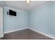 Cozy bedroom with fresh blue paint, modern TV hookups, and hardwood floors at 630 Daventry Ct, Clover, SC 29710