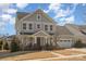 Charming two-story home with light blue siding, attached garage, and manicured landscaping at 630 Daventry Ct, Clover, SC 29710