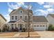 Inviting two-story home featuring light blue siding, garage, and well-maintained front yard at 630 Daventry Ct, Clover, SC 29710